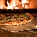 baked pizza on pizza peel in oven