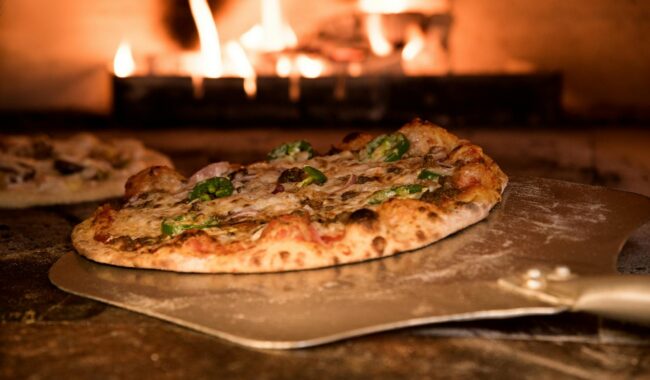 baked pizza on pizza peel in oven