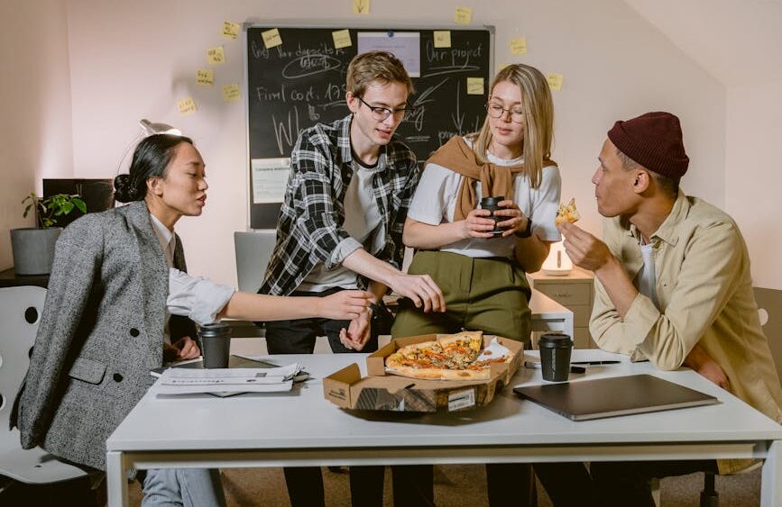people at the table eating in an office
